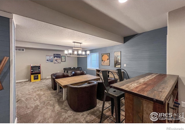 dining space featuring a textured ceiling and carpet floors