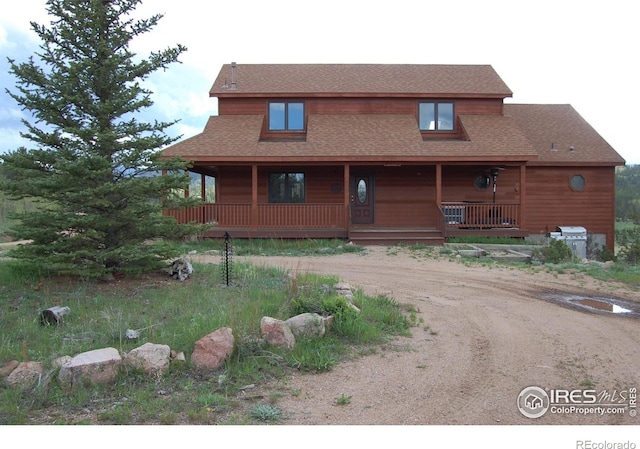 873 Huron Rd, Red Feather Lakes, CO 80545 - view of front of home featuring a porch, driveway, and roof with shingles