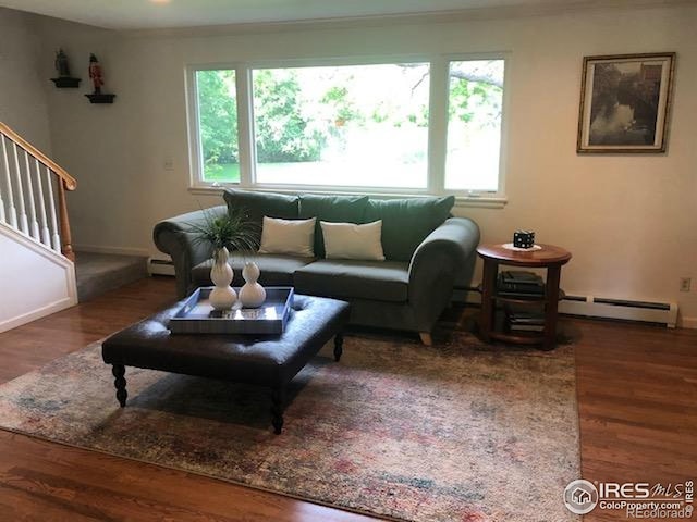 873 Cypress Dr, Boulder, CO 80303 - living room featuring a baseboard heating unit, healthy amount of natural light, stairway, and wood finished floors