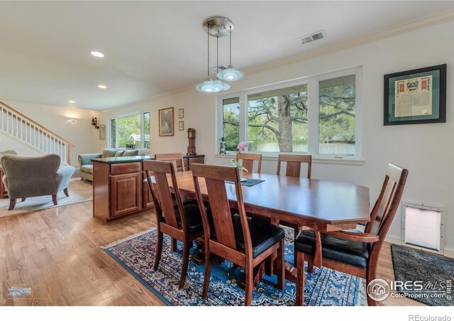 873 Cypress Dr, Boulder, CO 80303 - dining area with light wood finished floors, ornamental molding, stairs, and recessed lighting