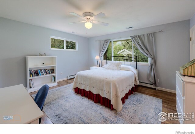 873 Cypress Dr, Boulder, CO 80303 - bedroom featuring wood finished floors, a baseboard heating unit, and a ceiling fan