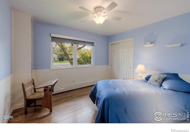 873 Cypress Dr, Boulder, CO 80303 - bedroom with a baseboard radiator, wood finished floors, a closet, and a ceiling fan