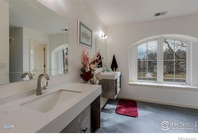 873 Cypress Dr, Boulder, CO 80303 - bathroom featuring healthy amount of natural light, two vanities, and tile patterned flooring