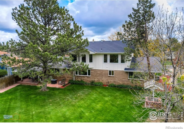873 Cypress Dr, Boulder, CO 80303 - back of property with brick siding, board and batten siding, a patio, and a shingled roof