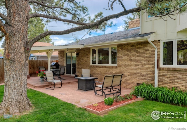873 Cypress Dr, Boulder, CO 80303 - back of property with brick siding, a patio, roof with shingles, and a chimney