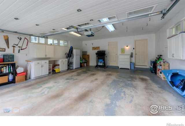 873 Cypress Dr, Boulder, CO 80303 - garage with freestanding refrigerator and a garage door opener