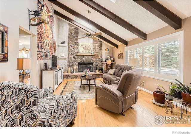 4057 Niblick Dr, Longmont, CO 80503 - living area featuring beam ceiling, a stone fireplace, hardwood / wood-style flooring, ceiling fan, and high vaulted ceiling