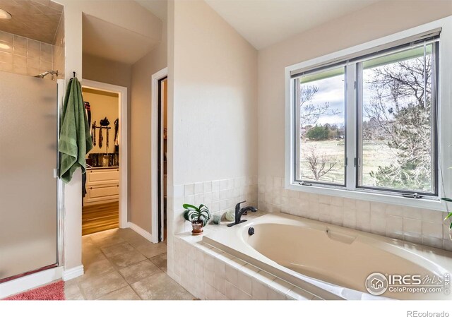 4057 Niblick Dr, Longmont, CO 80503 - bathroom with a bath, a stall shower, baseboards, and tile patterned floors
