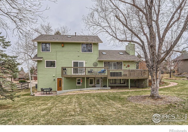 4057 Niblick Dr, Longmont, CO 80503 - rear view of house featuring a wooden deck, a patio area, and a chimney