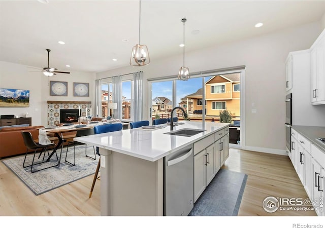 kitchen with a sink, ceiling fan, appliances with stainless steel finishes, recessed lighting, and light wood-style flooring