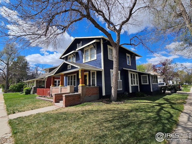 704 S 3rd Ave, Sterling, CO 80751 - view of side of home with a porch and a lawn