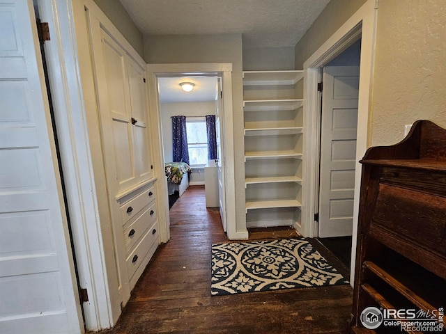 704 S 3rd Ave, Sterling, CO 80751 - hall with dark wood-style flooring