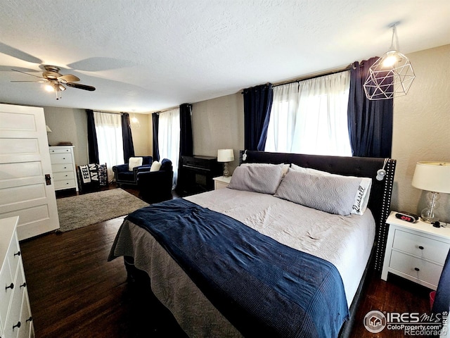 704 S 3rd Ave, Sterling, CO 80751 - bedroom with a ceiling fan, a textured ceiling, and wood finished floors