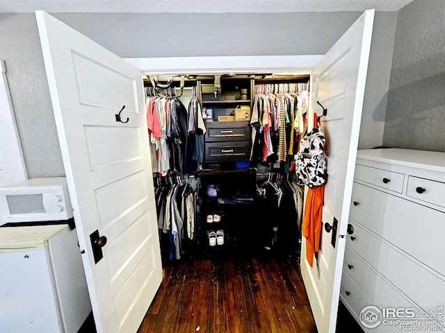 704 S 3rd Ave, Sterling, CO 80751 - walk in closet with dark wood-style floors