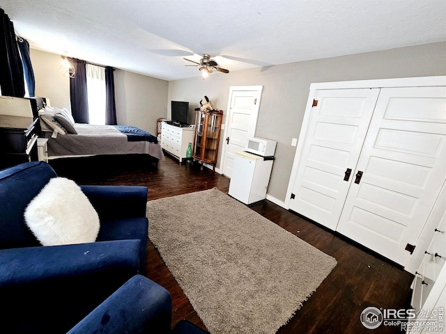 704 S 3rd Ave, Sterling, CO 80751 - bedroom featuring dark wood-style flooring, a ceiling fan, and baseboards