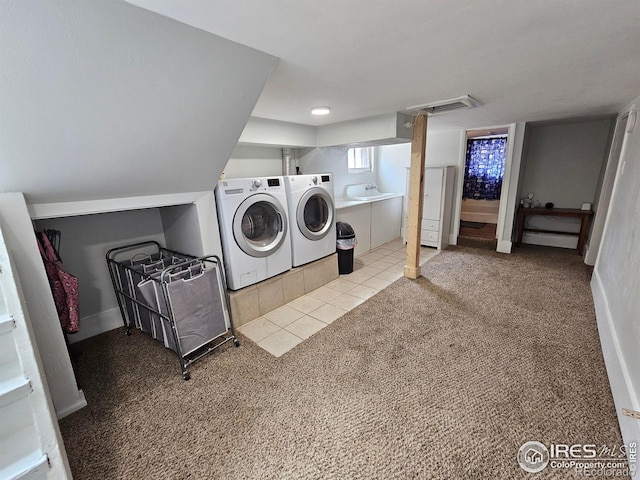 704 S 3rd Ave, Sterling, CO 80751 - laundry room with laundry area, carpet flooring, washing machine and dryer, and visible vents