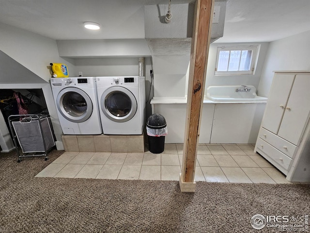704 S 3rd Ave, Sterling, CO 80751 - washroom featuring tile patterned floors, washing machine and dryer, a sink, and carpet