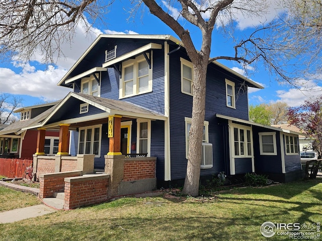704 S 3rd Ave, Sterling, CO 80751 - view of front facade featuring a porch, central AC unit, and a front yard