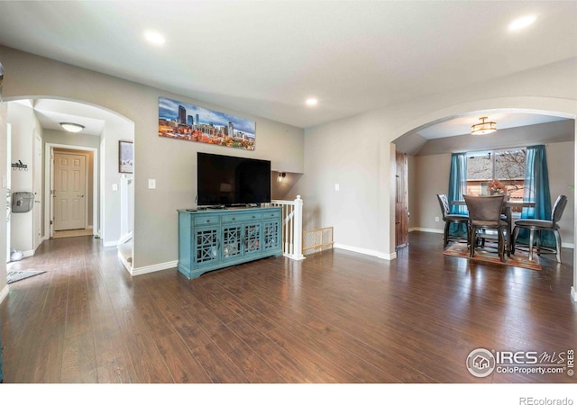2821 5th St SW, Loveland, CO 80537 - living room with baseboards, arched walkways, wood finished floors, and recessed lighting