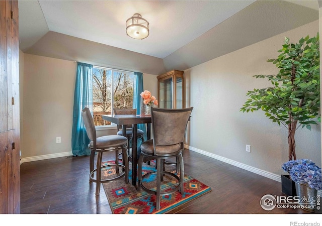2821 5th St SW, Loveland, CO 80537 - dining area featuring vaulted ceiling, baseboards, and dark wood-style floors
