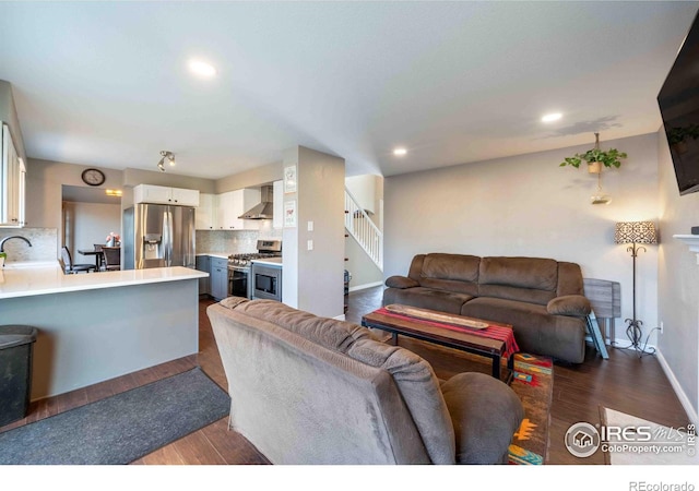 2821 5th St SW, Loveland, CO 80537 - living area with baseboards, recessed lighting, dark wood-type flooring, and stairway