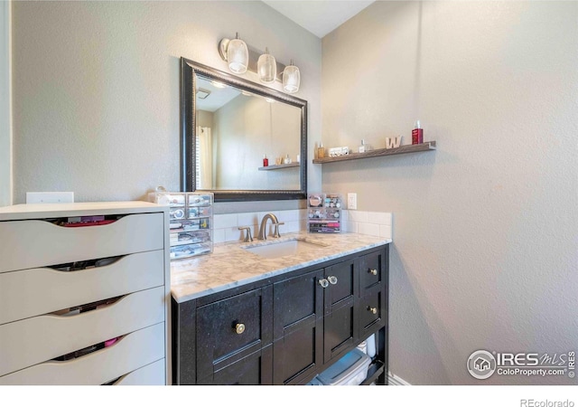 2821 5th St SW, Loveland, CO 80537 - bathroom featuring a textured wall and vanity