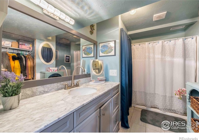 2821 5th St SW, Loveland, CO 80537 - full bath with a shower with shower curtain, vanity, and tile patterned floors