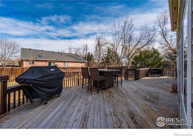 2821 5th St SW, Loveland, CO 80537 - deck with a fenced backyard, outdoor dry bar, and area for grilling