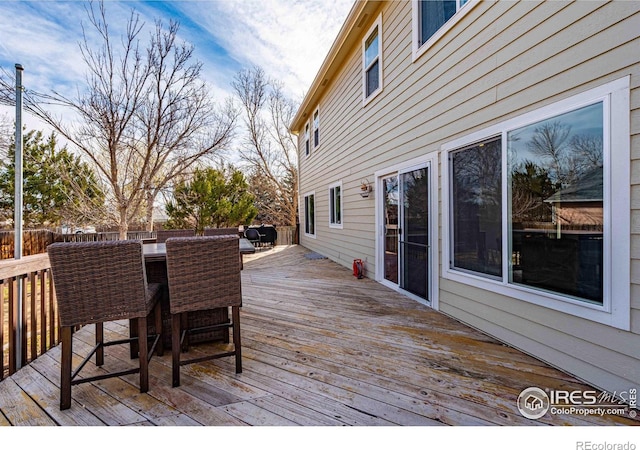 2821 5th St SW, Loveland, CO 80537 - wooden deck with a fenced backyard and outdoor dining space