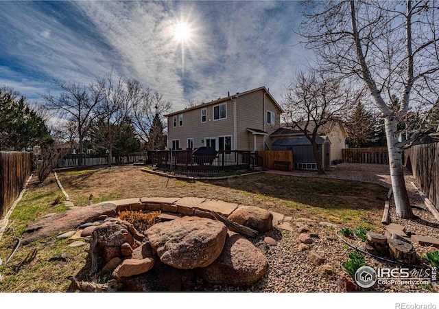 2821 5th St SW, Loveland, CO 80537 - view of yard with a fenced backyard, a storage unit, an outdoor structure, and a deck