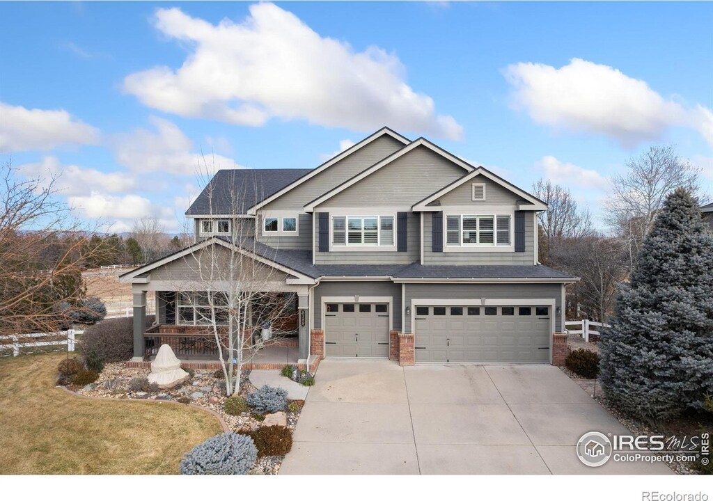 craftsman-style house with driveway, an attached garage, and brick siding