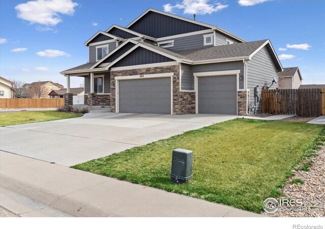 403 S Maple Ave, Eaton, CO 80615 - craftsman house with a garage, concrete driveway, stone siding, and board and batten siding