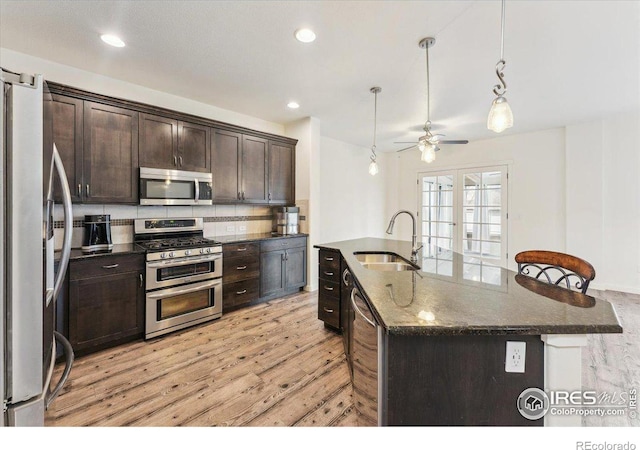 403 S Maple Ave, Eaton, CO 80615 - kitchen featuring appliances with stainless steel finishes, a sink, light wood finished floors, ceiling fan, and dark brown cabinetry