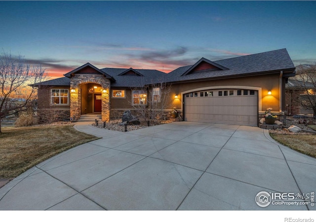 1046 Greens Pl, Erie, CO 80516 - view of front facade with stone siding, driveway, a garage, and a shingled roof