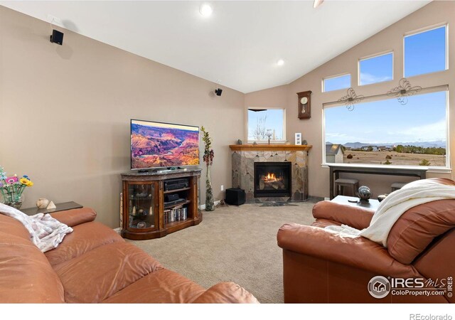 1046 Greens Pl, Erie, CO 80516 - carpeted living area featuring a fireplace with flush hearth, recessed lighting, and high vaulted ceiling