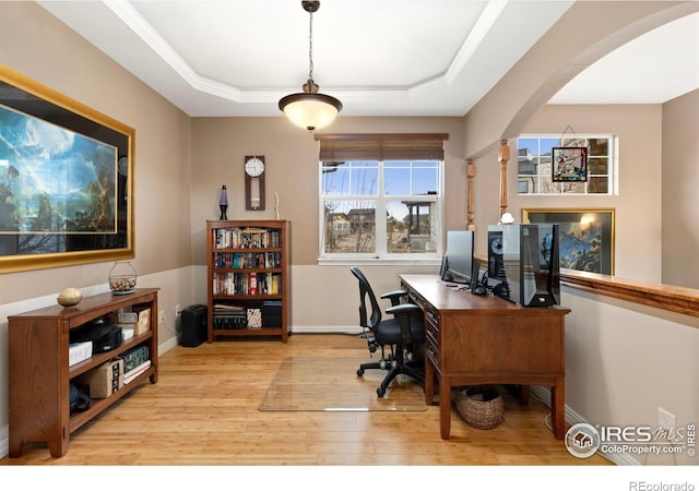 1046 Greens Pl, Erie, CO 80516 - home office with arched walkways, wood finished floors, baseboards, and a raised ceiling