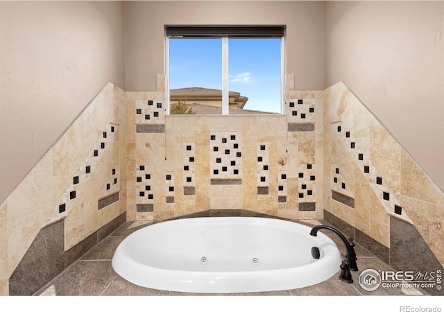 1046 Greens Pl, Erie, CO 80516 - bathroom featuring tile walls, a whirlpool tub, and a wainscoted wall