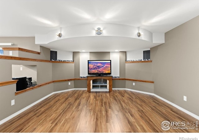 1046 Greens Pl, Erie, CO 80516 - unfurnished living room featuring wood finished floors and baseboards