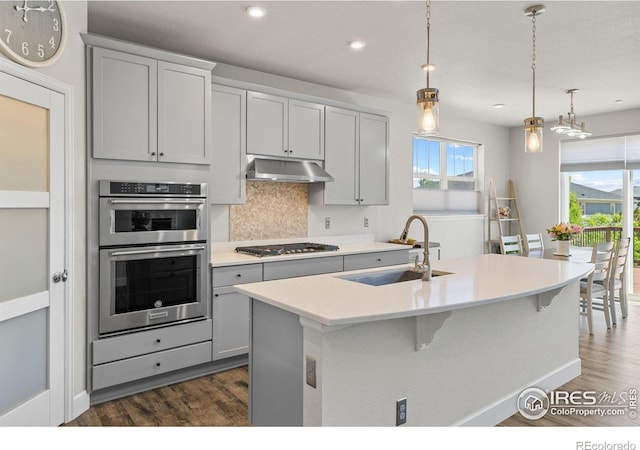 1863 Pioneer Cir, Lafayette, CO 80026 - kitchen featuring a sink, under cabinet range hood, stainless steel appliances, dark wood-style flooring, and recessed lighting
