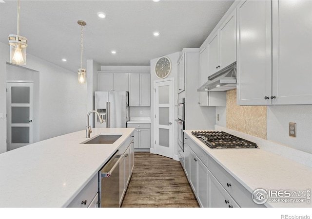 1863 Pioneer Cir, Lafayette, CO 80026 - kitchen featuring appliances with stainless steel finishes, under cabinet range hood, a sink, dark wood finished floors, and recessed lighting