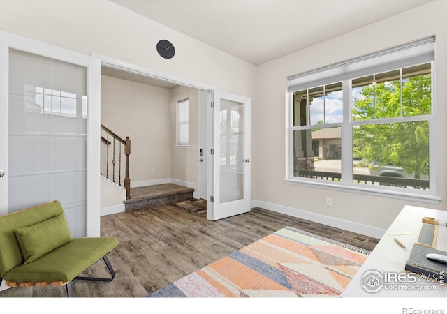 1863 Pioneer Cir, Lafayette, CO 80026 - entrance foyer with stairs, wood finished floors, healthy amount of natural light, and french doors