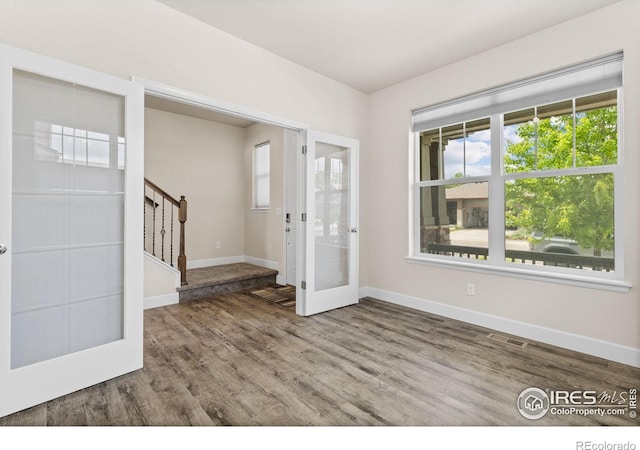 1863 Pioneer Cir, Lafayette, CO 80026 - entrance foyer featuring french doors, stairway, plenty of natural light, and wood finished floors