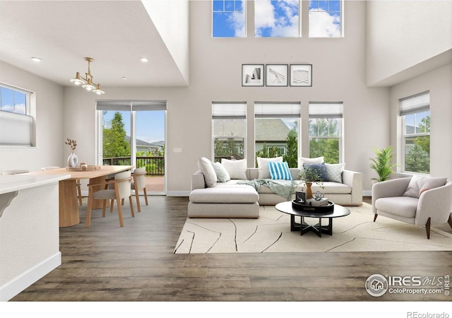 1863 Pioneer Cir, Lafayette, CO 80026 - living area featuring wood finished floors, recessed lighting, a towering ceiling, and a chandelier
