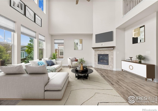 1863 Pioneer Cir, Lafayette, CO 80026 - living area featuring a high ceiling, a glass covered fireplace, and wood finished floors