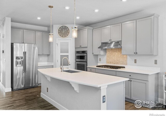 1863 Pioneer Cir, Lafayette, CO 80026 - kitchen featuring stainless steel appliances, under cabinet range hood, gray cabinets, dark wood-type flooring, and recessed lighting