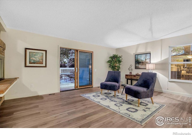 8940 W 80th Dr, Arvada, CO 80005 - living area with wood finished floors and a textured ceiling
