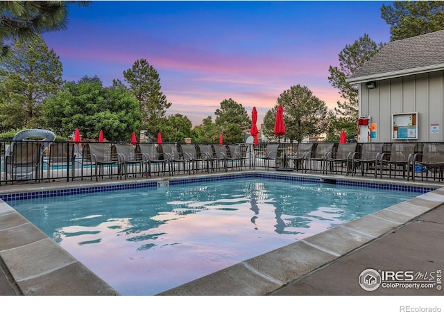 8940 W 80th Dr, Arvada, CO 80005 - pool at dusk featuring a community pool