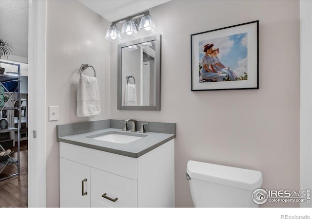 8940 W 80th Dr, Arvada, CO 80005 - half bath with vanity and wood finished floors