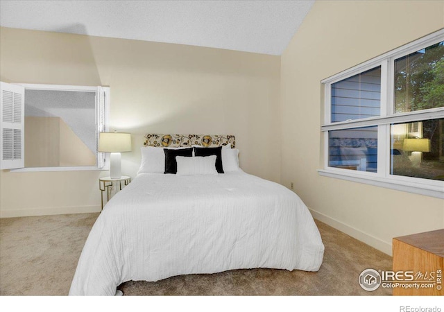 8940 W 80th Dr, Arvada, CO 80005 - carpeted bedroom featuring lofted ceiling and baseboards