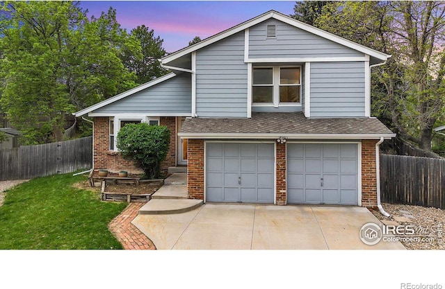 8940 W 80th Dr, Arvada, CO 80005 - view of front of home featuring brick siding, a garage, driveway, and a shingled roof